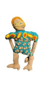 soft sculpture of a woman - wearing colourful frock