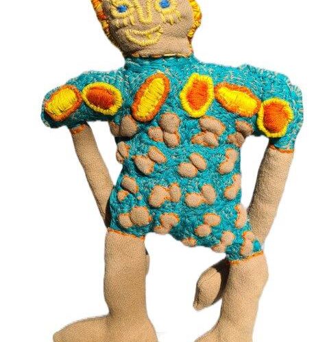 soft sculpture of a woman - wearing colourful frock